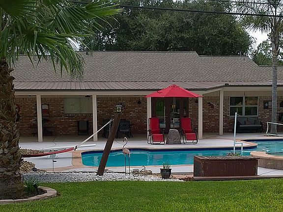 This backyard has it all! You will be amazed with this yard! Pool, Green Space, Outdoor Kitchen & Mo