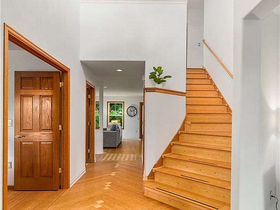 As you enter you will find beautiful custom inlaid floors, an imported chandelier and one of two staircases 