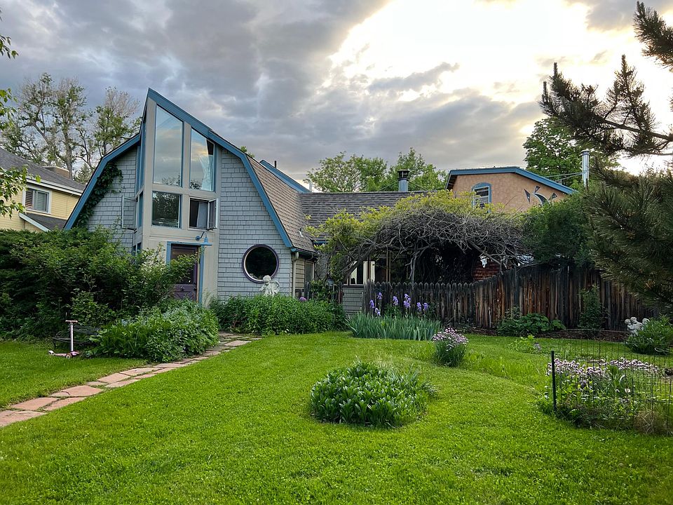 Large front yard with shade trees and gardens