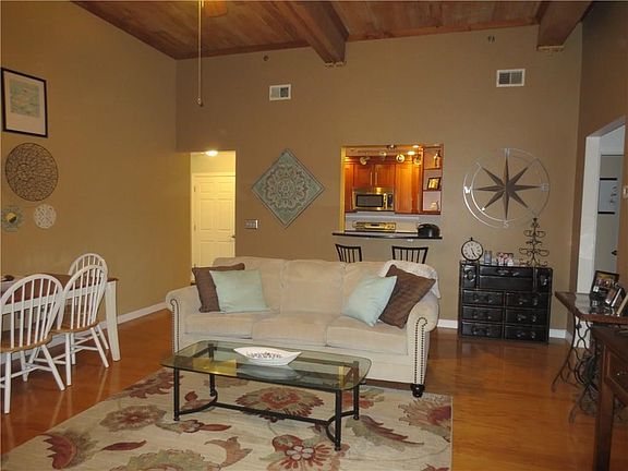 Kitchen pass thru, hardwood floors, wood ceilings