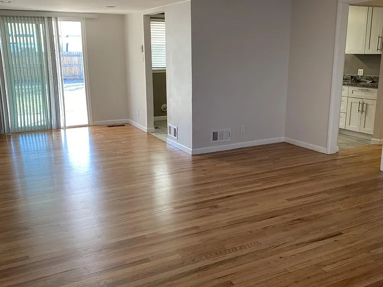 Photo taken from living room toward dining area, glass doors to covered patio