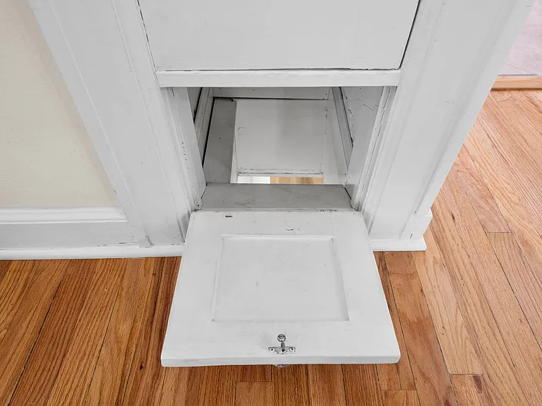 Laundry shoot located on landing between main floor bedrooms and bathroom