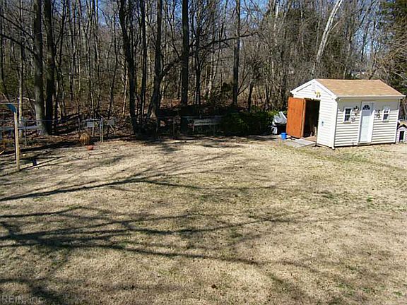 Fenced in backyard with shed