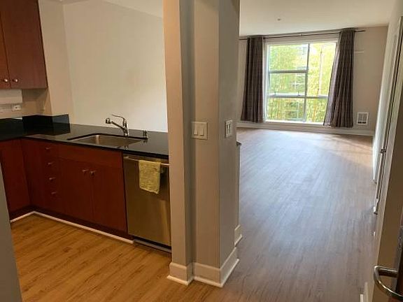 entering unit, looking at living room with kitchen on left side.