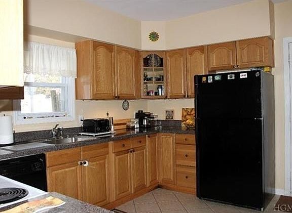 Sun filled living room with hardwood floors.
