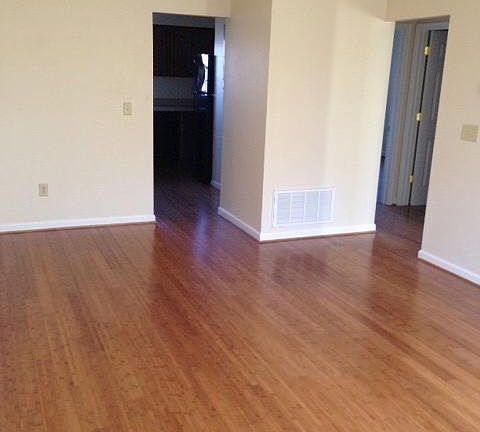 Living room. looking towards kitchen (left) and hallway to bedrooms/bath (right)
