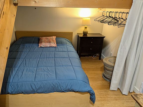 Queen bed, nightstand with lamp, clothes organization