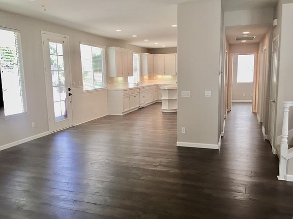 Kitchen view, hallway leading to downstairs bedroom, bath & laundry from Family room
