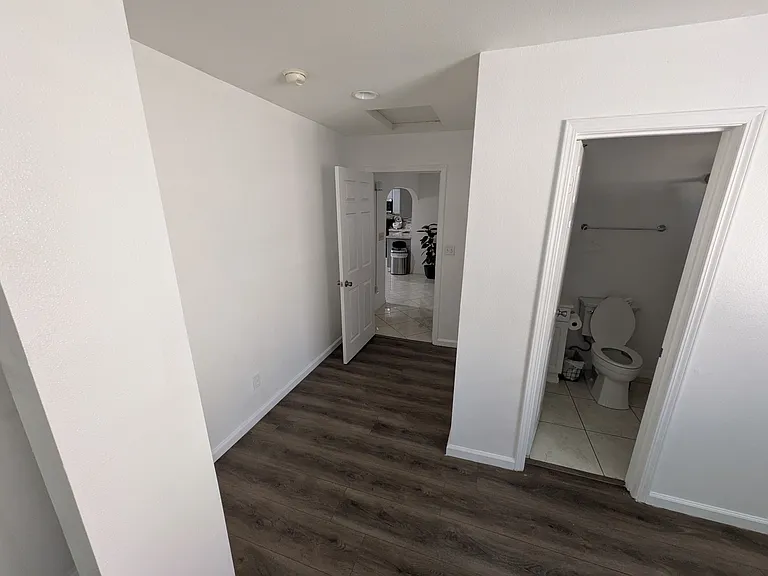 Shot of the entrance walkway of the room standing by the closet.