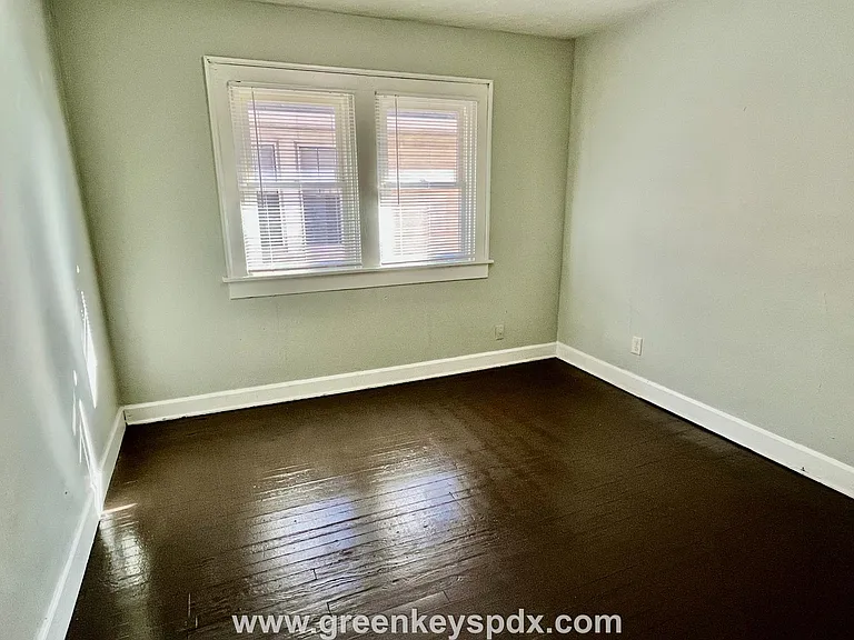 Bedroom with windows and painted floors