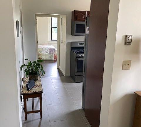 View of hall from Living room thru Kitchen to Bedroom