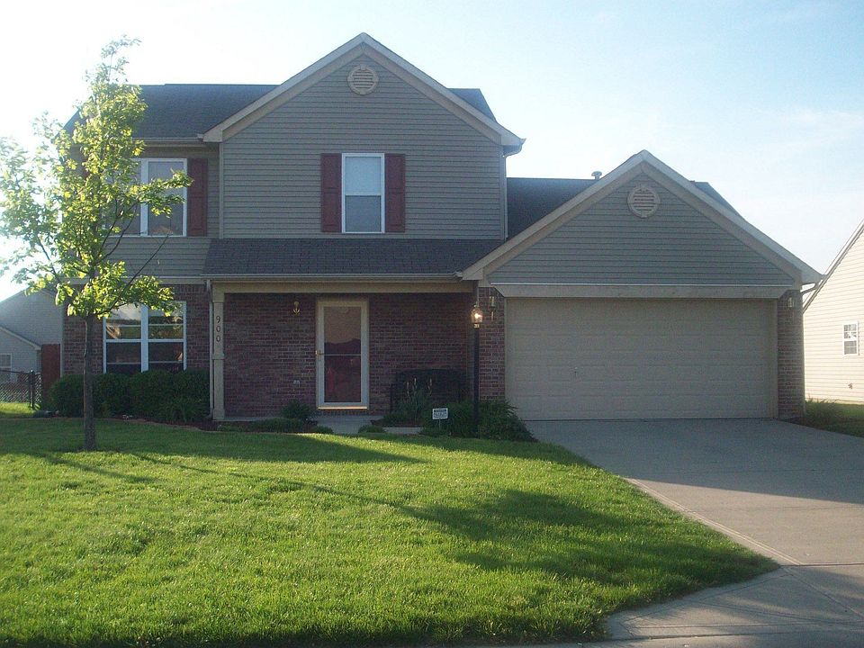 Red rock landscaping in front, red cedar mulch & & iris' line side of home