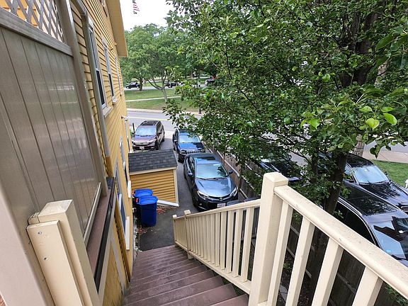View of the parking area from the top of the outside stairs. Unit 2 parking space is the single space on the left.