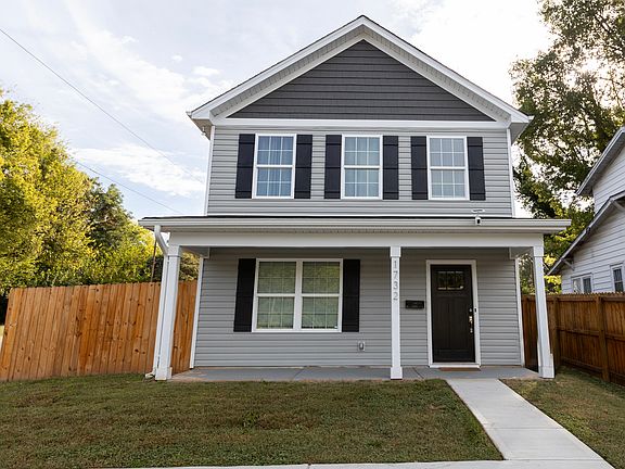 Front view of porch and parking pad. The parking pad fits up to 3 cars.