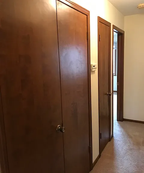 hallway to bedrooms, shows additional closet space on the left