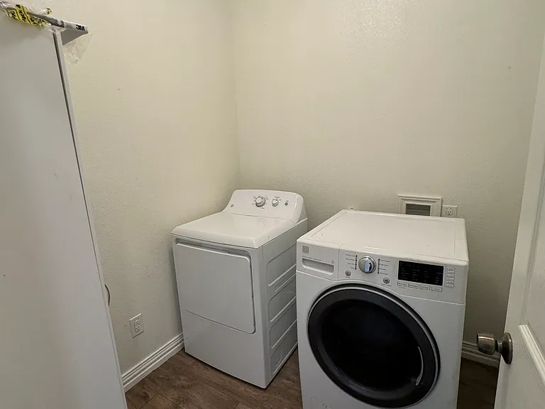 Laundry room with gas dryer and electric washer.
