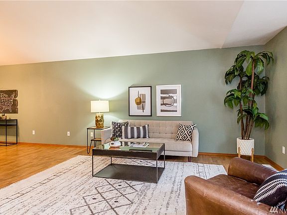 Open Concept Living Room with Tall Vaulted Ceilings Which Welcome Natural Light
