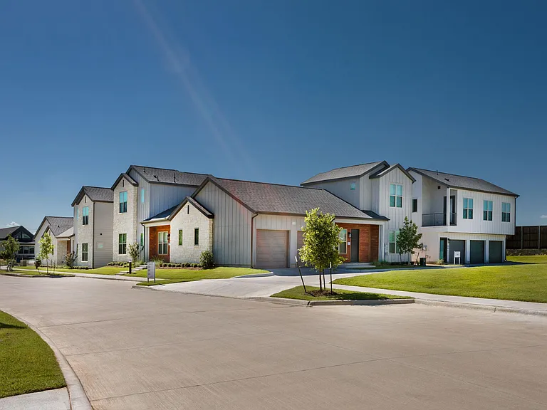 Row of luxury rental homes with green spaces