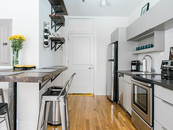 Updated kitchen with stainless steel appliances and custom built-ins
