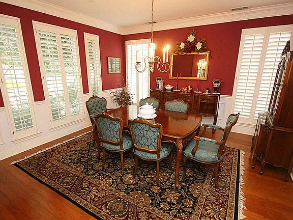 The square shaped dining room makes furniture placement easy and comfortable. There are  windows with Plantation shutters on two sides. The floors are hardwood and the dining room chandelier has been updated.