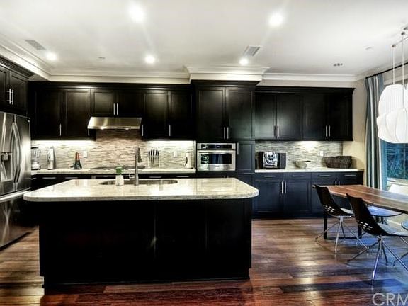 Chef-Inspired Gourmet Kitchen with Granite Countertops, FULL Decorative Stone Backsplash, Shaker Style Maple Espresso Cabinetry and ALL Whirlpool and KitchenAid Stainless Steel Appliances!