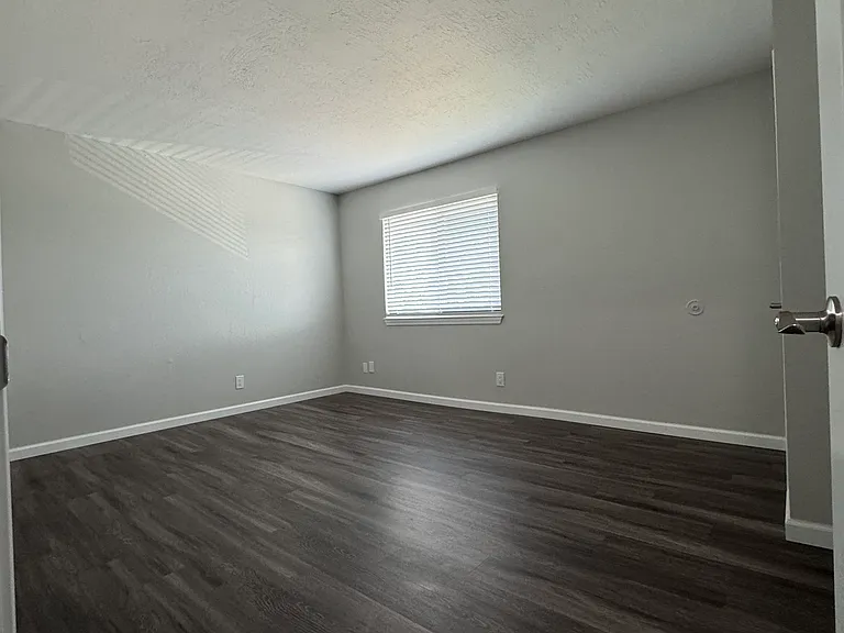 Bedroom #1 has new flooring, large window including window blinds for bright, natural light and a spacious walk-in closet