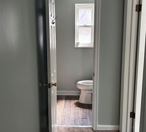 Hallway looking into bathroom. Bedroom #2 on the right