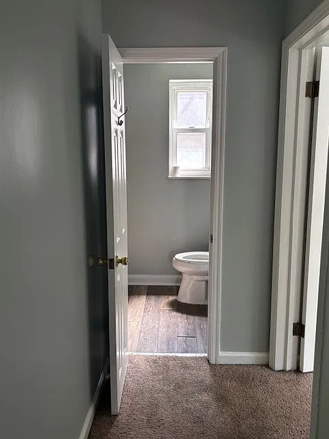 Hallway looking into bathroom. Bedroom #2 on the right