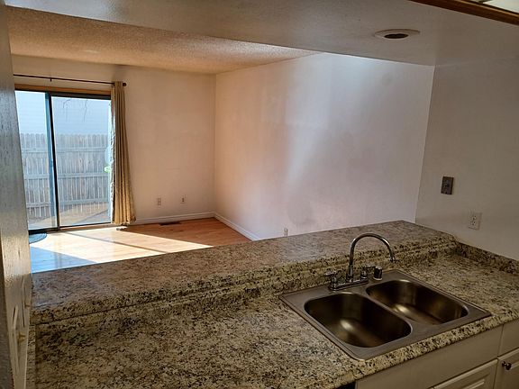 View over countertop and breakfast bar into lounge.