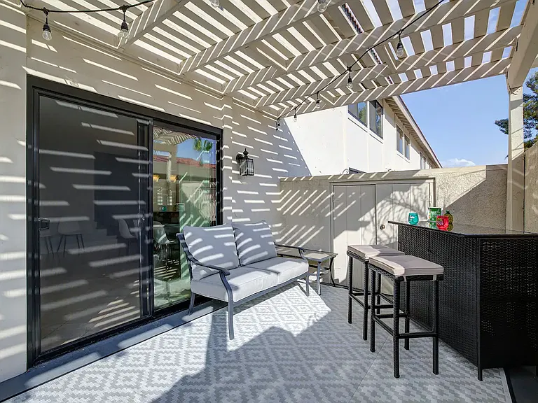 Back Patio. Contains bar area and love seat. Storage area houses all furniture covers for both patios.