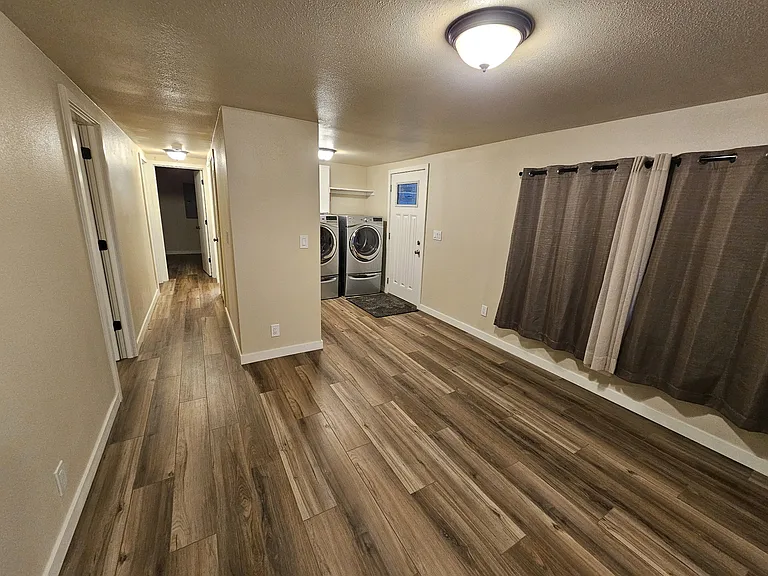 Informal dining area, utility room, and hallway to bedrooms and baths