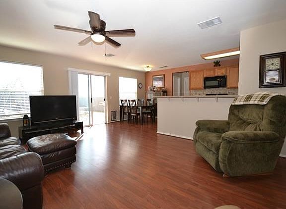 Beautiful laminate floors in living room open to kitchen and din