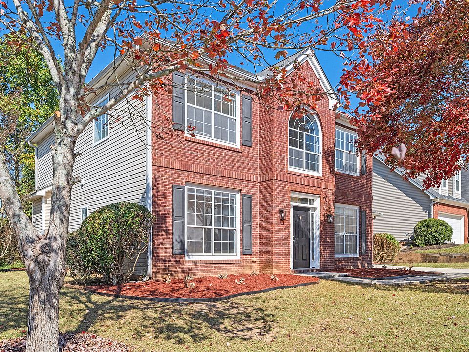 Beautifully landscaped,Two-story red brick front home.
