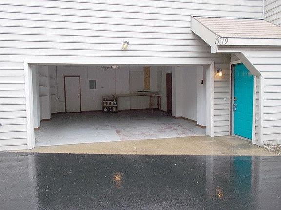 2 car garage, shelving, storage room off garage