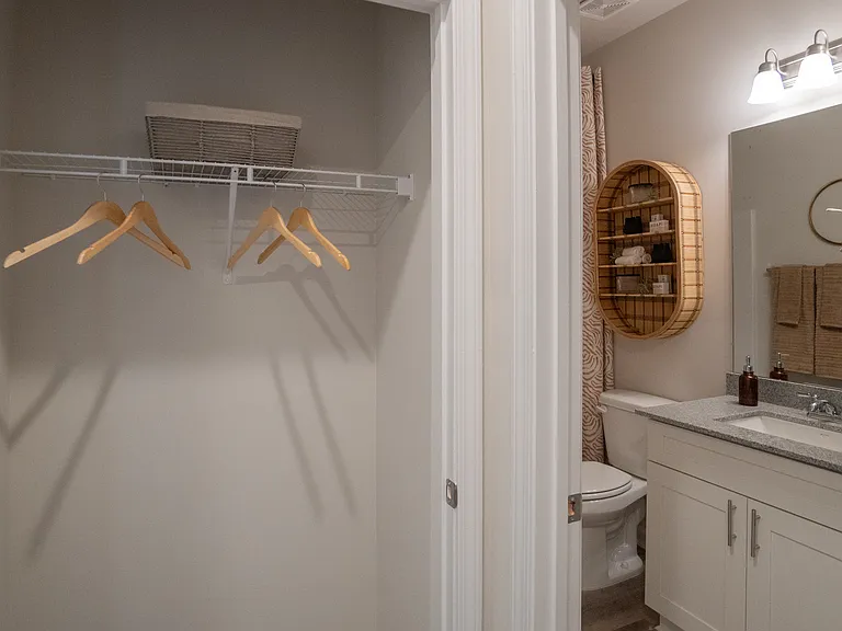 Secondary Bathroom with single vanity and coat closet in the hallway.
