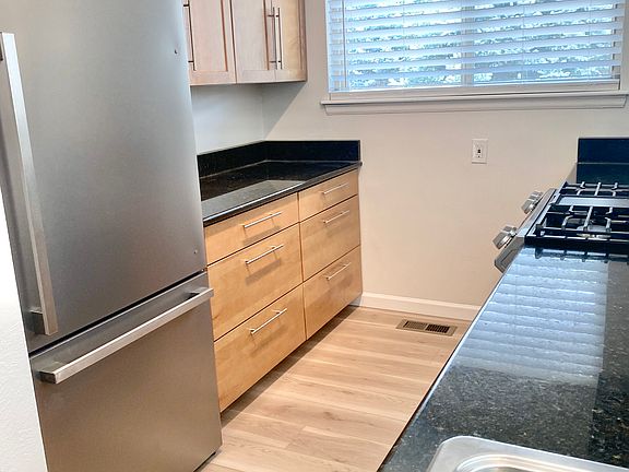 Renovated kitchen, new cabinets, new fridge.