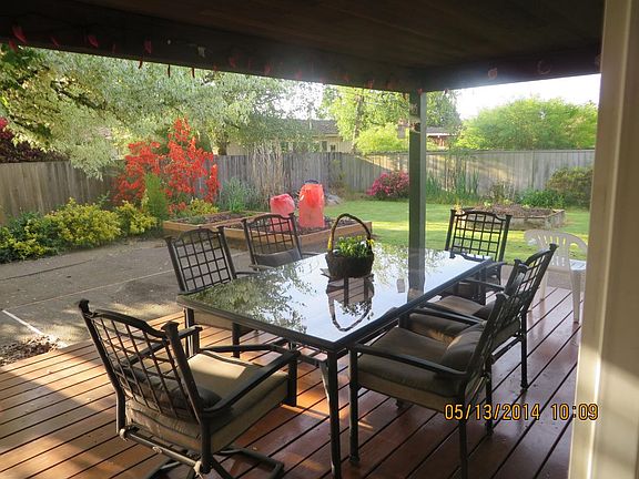 Covered porch with table and chairs
