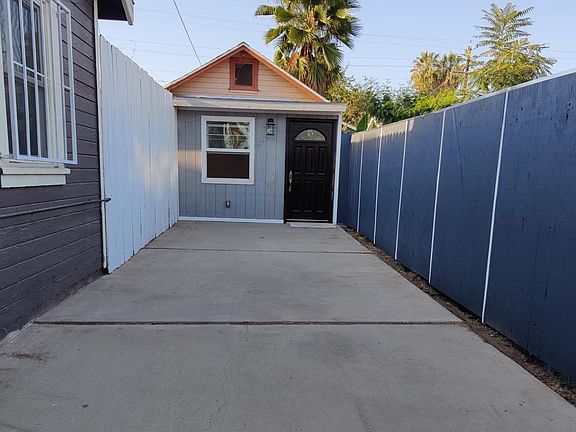 Large front yard patio with privacy fence