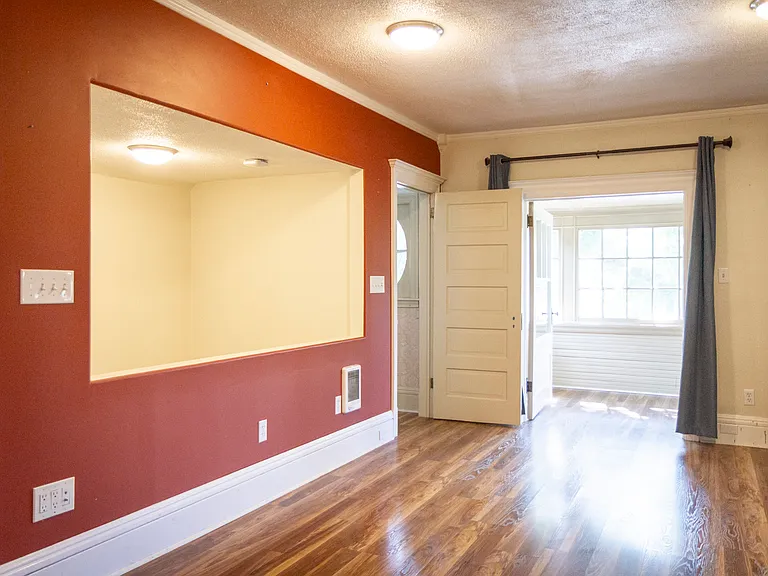living room with 2 closet/office nooks and front glassed-in deck
