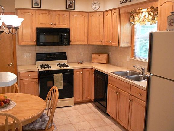 Remodeled Kitchen with Maple Cabinets, Designer Flooring, & Recessed Lighting
