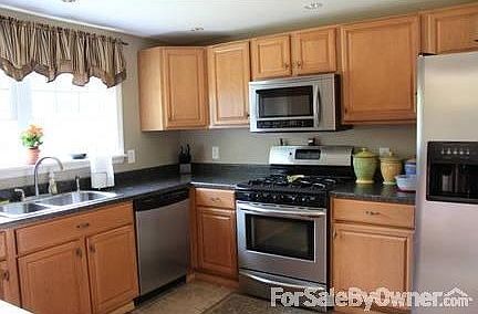 Modern Kitchen with heated tile floor : Pantry closet for extra storage space.