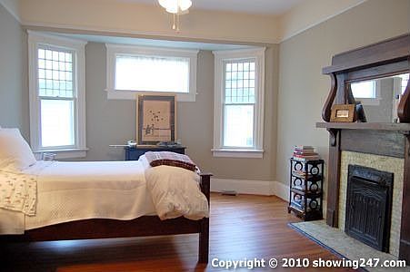 Large second bedroom with fireplace and great natural light beaming thru the windows.