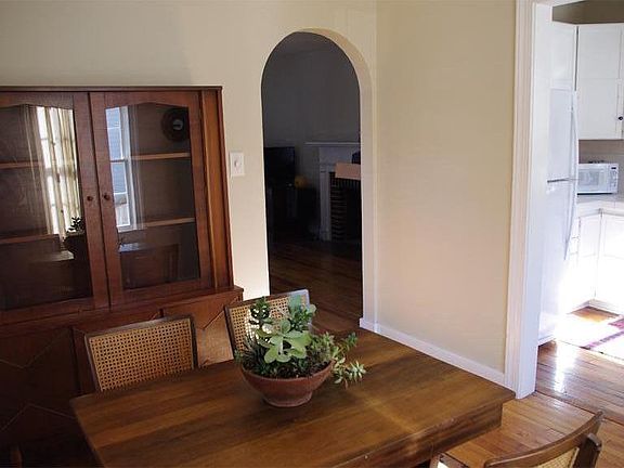 Dining room peeking into living room and kitchen