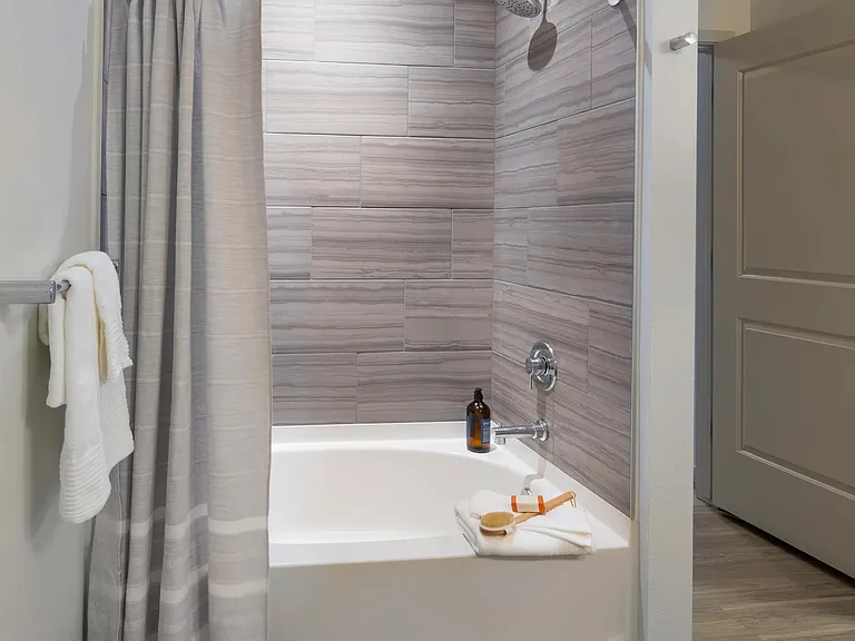 Oversized tub-shower in bathroom in apartment at Modera West Wash Park