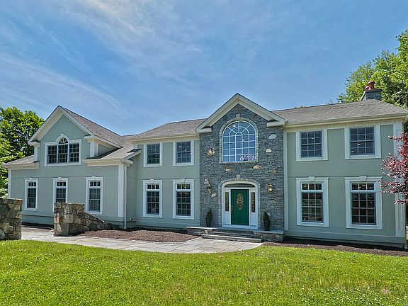Stucco home & stone wall