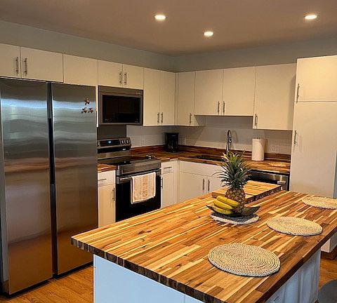 Stylishly remodeled kitchen with a charming inlaid butcher block countertop_perfect for prepping meals or hosting with flair