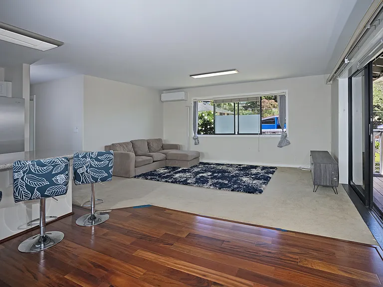 Living Room (2nd Floor) with Split AC Unit and Four (4) Glass Sliding Doors Opening Up to Balcony Facing the Ocean