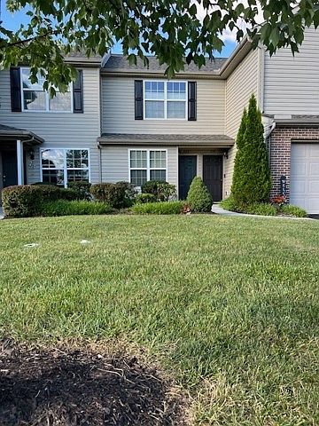 Landscaped Entry with garage and driveway parking.