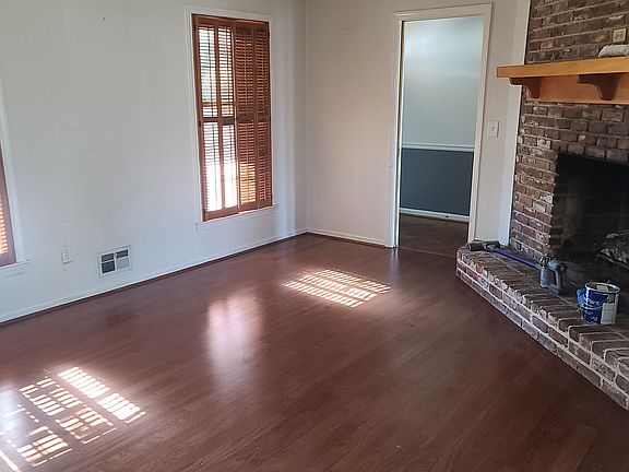 Den/Dining room with gas log fireplace.