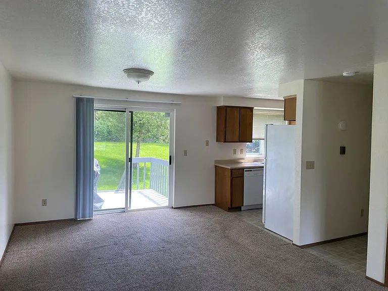 Open living and dining area with easy access to the kitchen and private deck